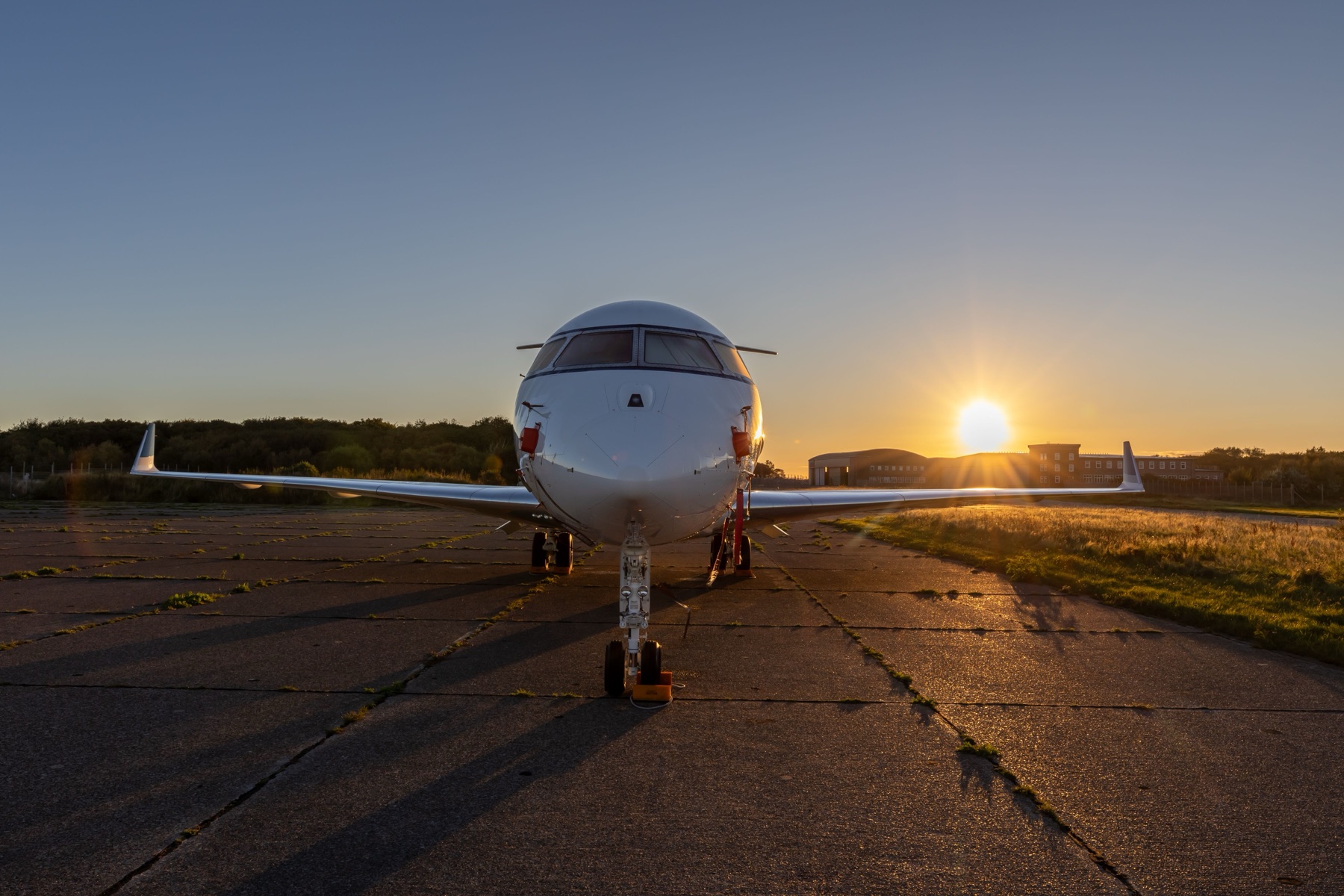 Private jet at sunset on the runway